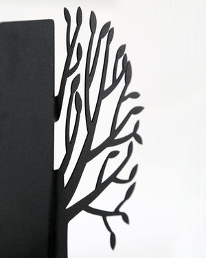 Tree of Life metal bookends holding a row of books