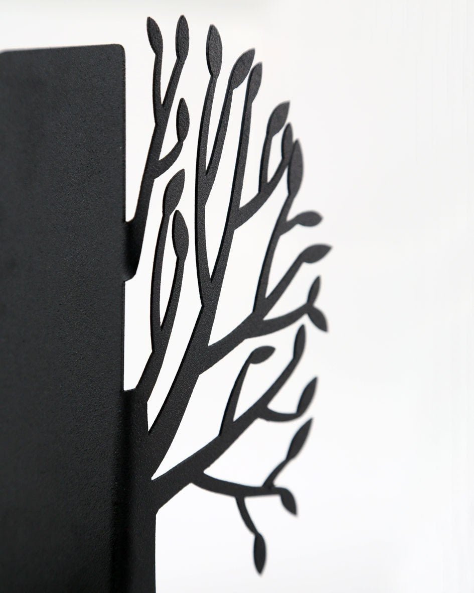 Tree of Life metal bookends holding a row of books