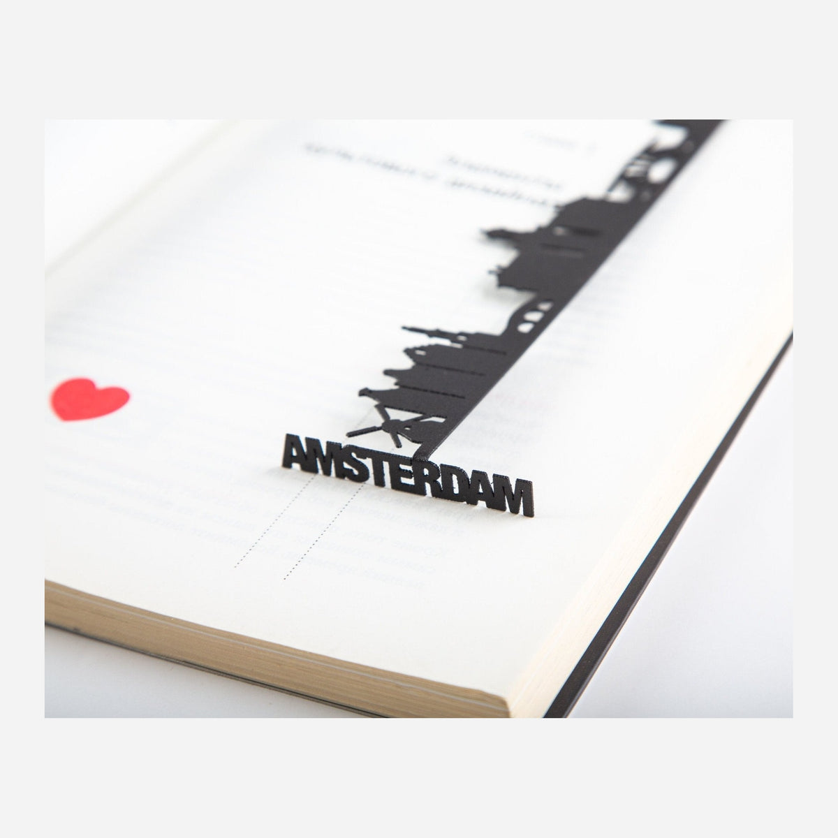 Trip Journal Amsterdam Cityscape metal bookmark marking a page in a notebook