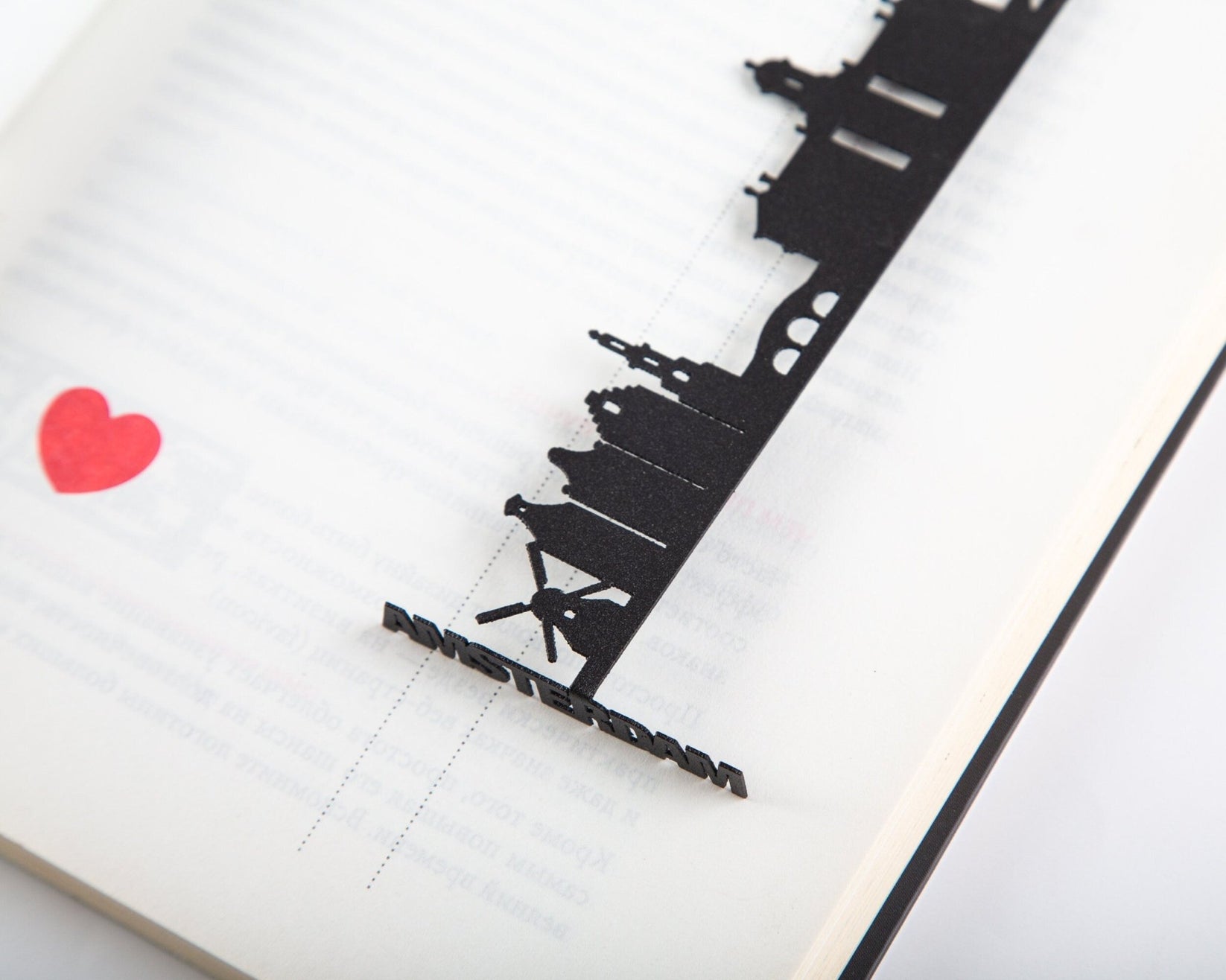 Trip Journal Amsterdam Cityscape metal bookmark tucked into a notebook