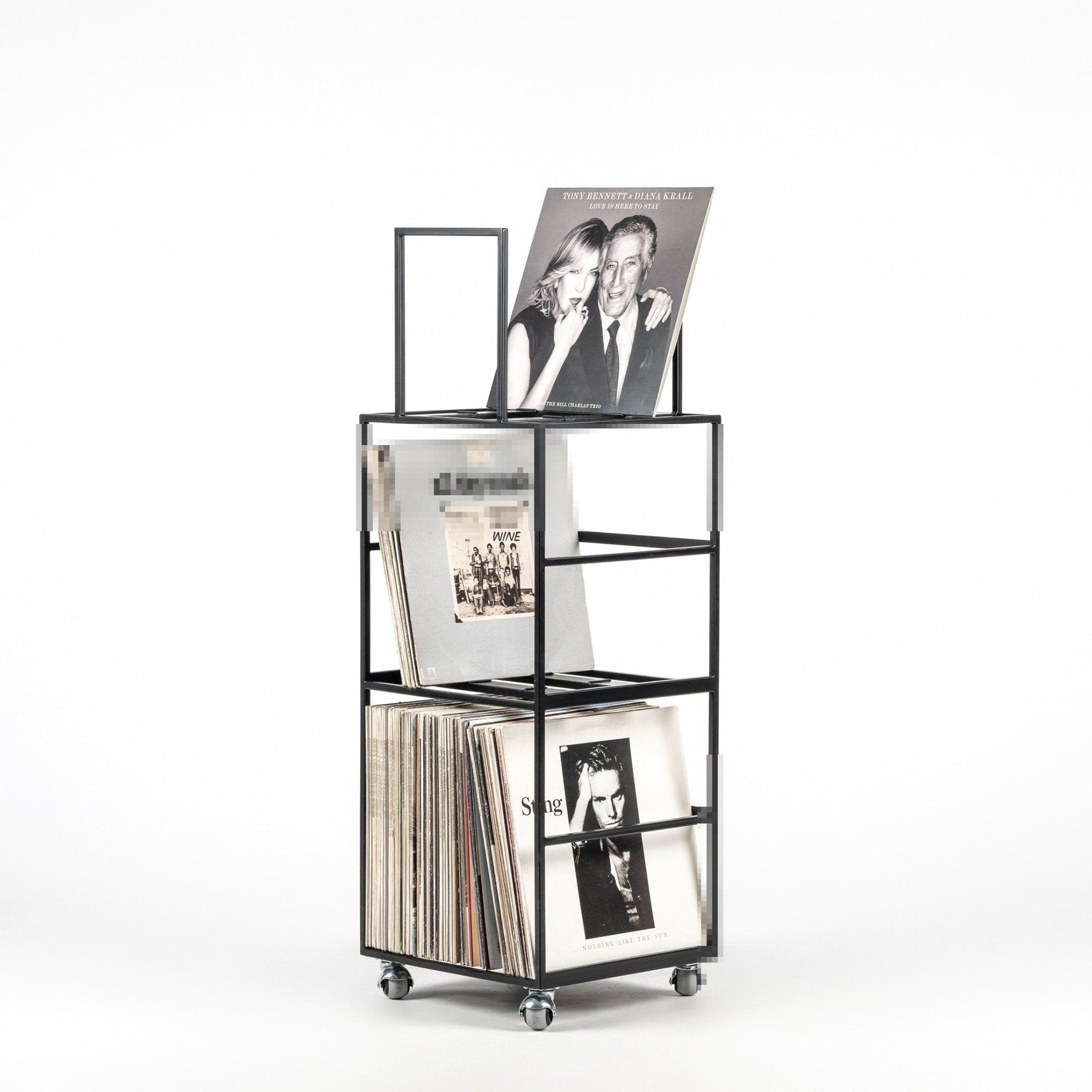 Black metal vinyl record storage cart on wheels by DesignAtelierArticle, filled with LPs including a featured display of Tony Bennett & Diana Krall album, minimalist and compact design.