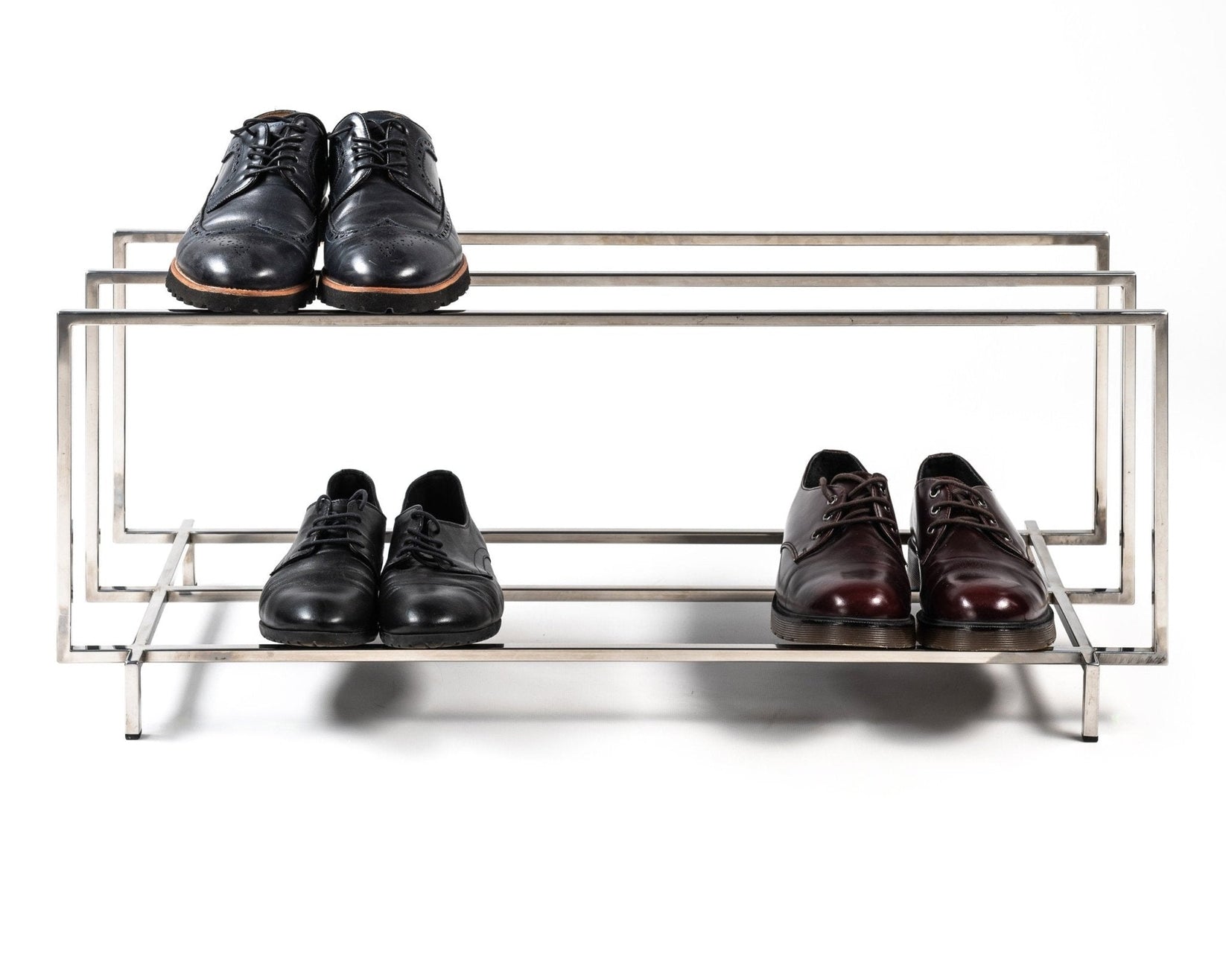 Stainless steel shoe rack holding shoes on both tiers - Atelier Article
