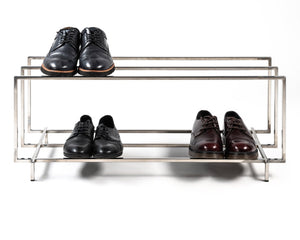 Stainless steel shoe rack holding shoes on both tiers - Atelier Article