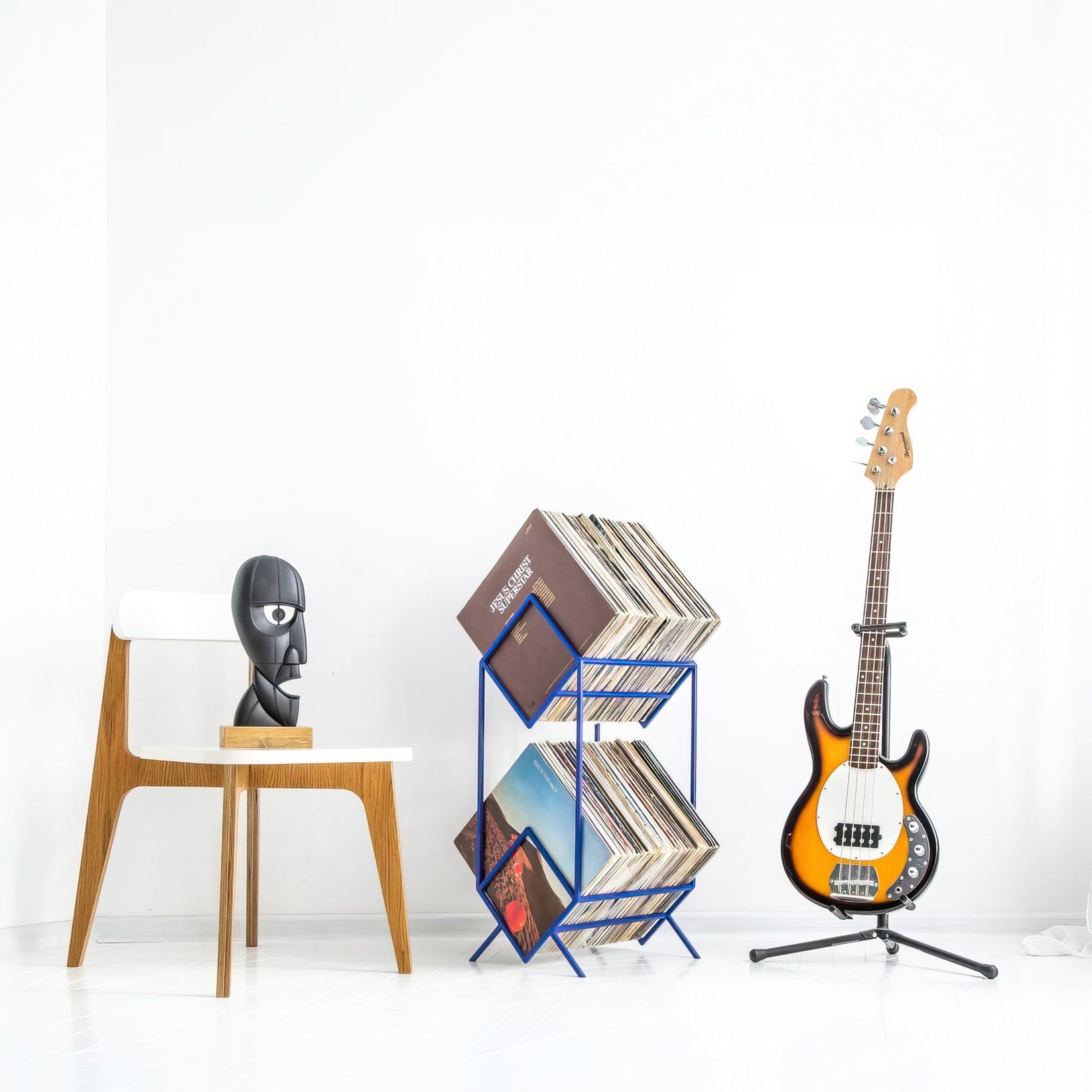 Blue Atelier Article 2Romb vinyl record stand in a music room with bass guitar