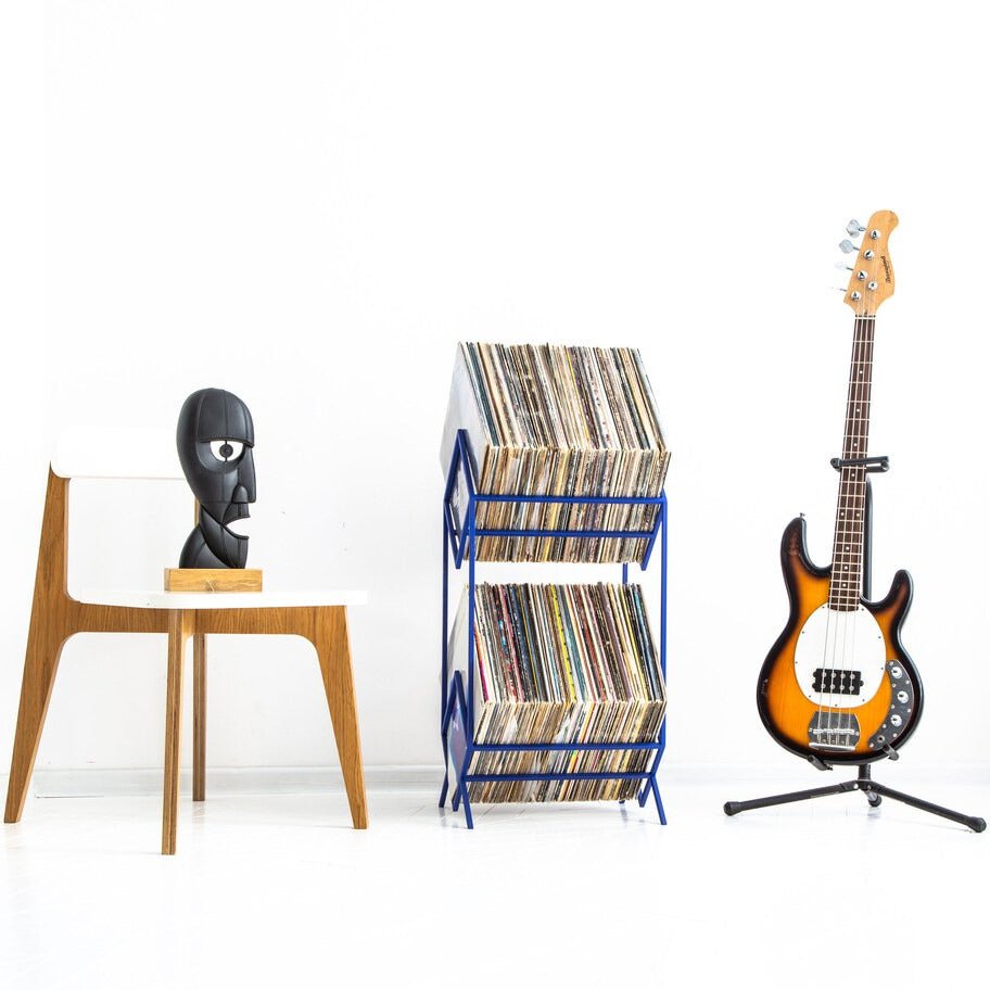 Blue Atelier Article 2Romb two-tier record stand beside a bass guitar and chair