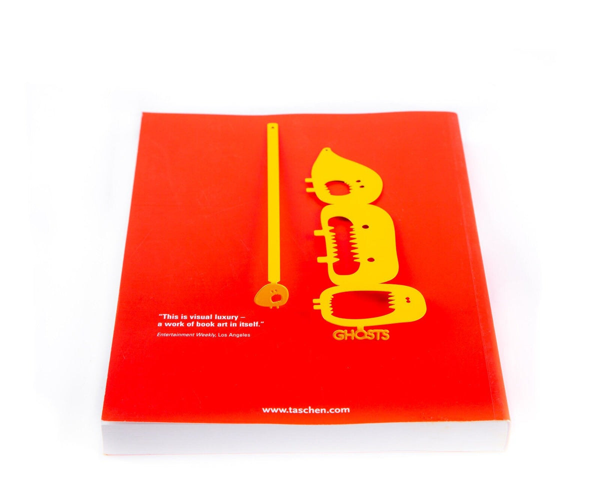 Three Screaming Monsters metal bookmark in gold on a coloured background