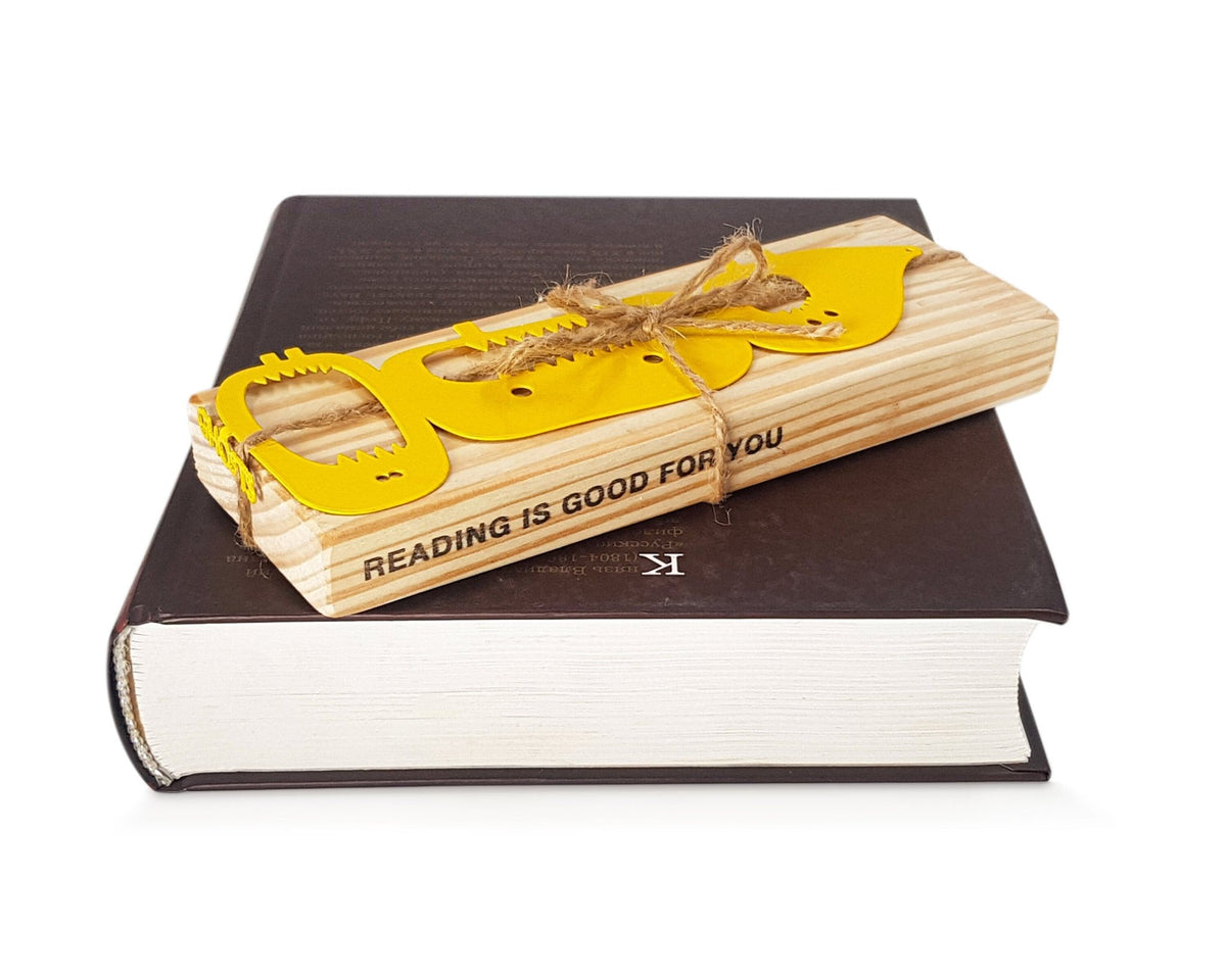 Three Screaming Monsters metal bookmark in gold with the engraved wooden gift block it ships with
