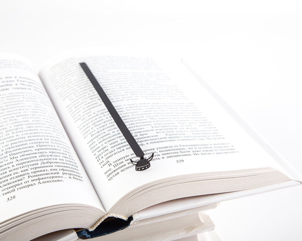 Viking Horned Helmet metal bookmark resting on the pages of an open book