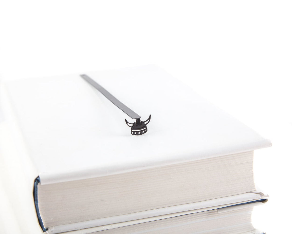 Viking Horned Helmet metal bookmark in a closed book, only its top showing above the pages