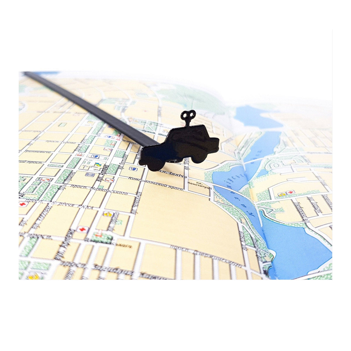 Wind-Up Toy Car metal bookmark on a coloured background