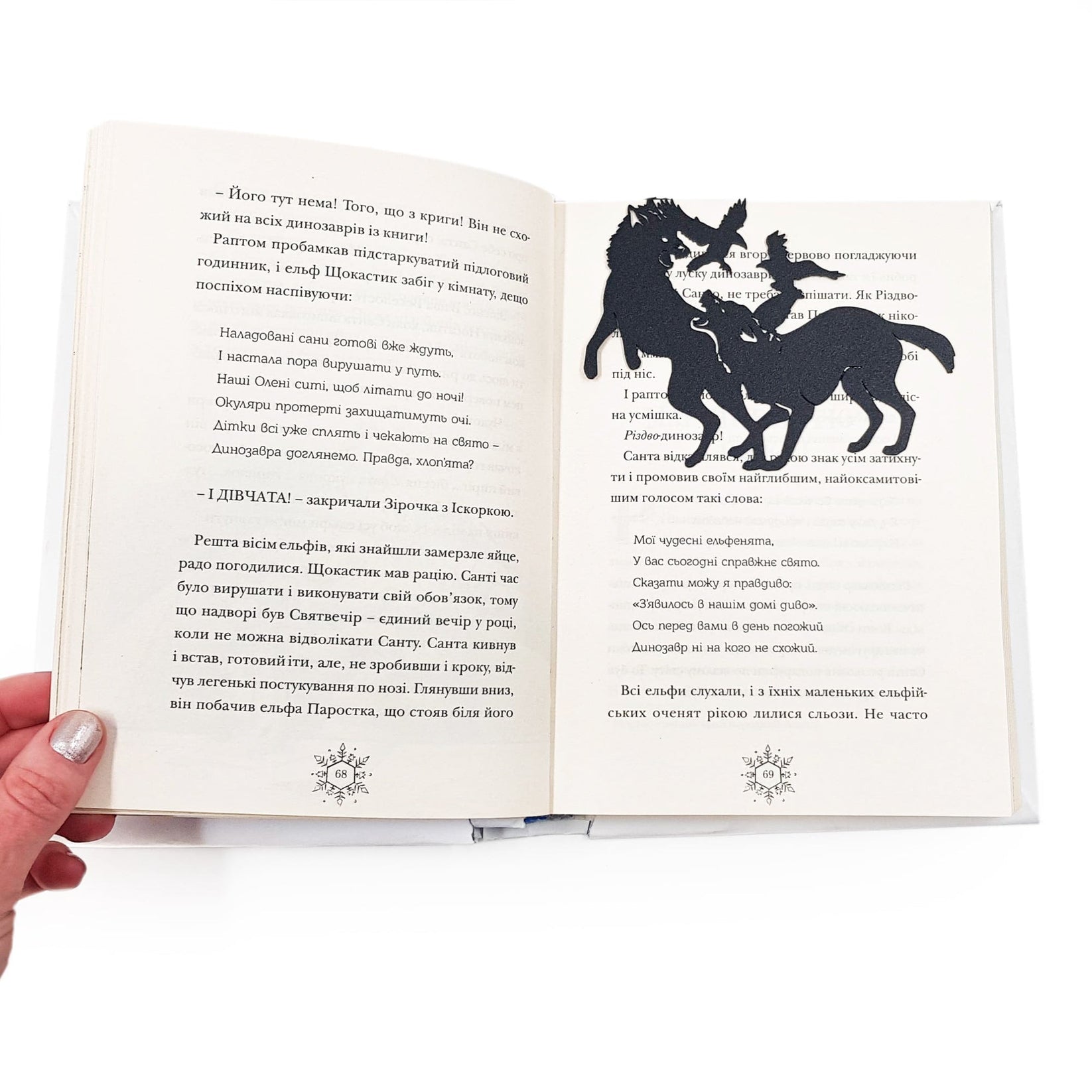 Wolves & Raven metal bookmark marking a page in an open book
