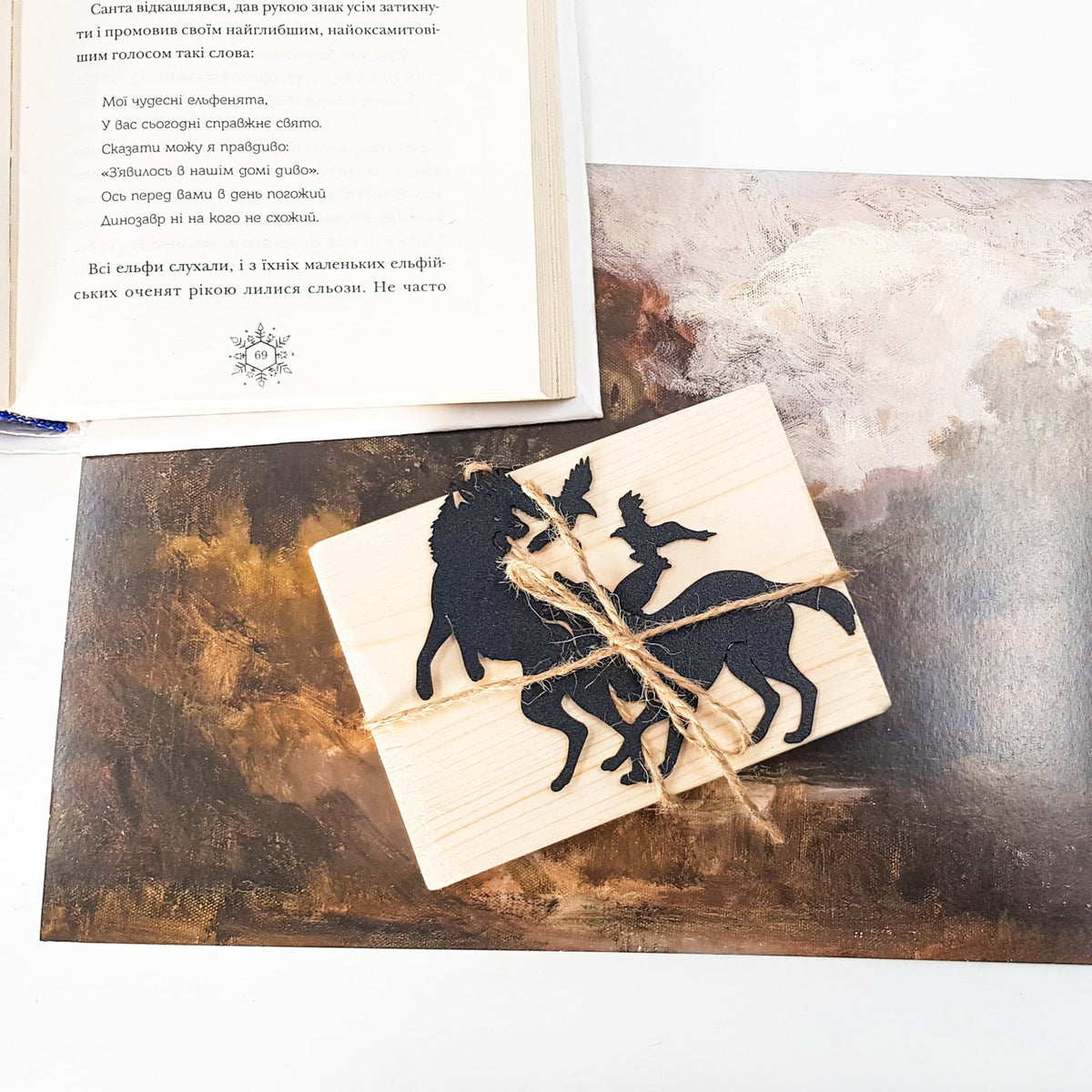 Wolves & Raven metal bookmark on a coloured background