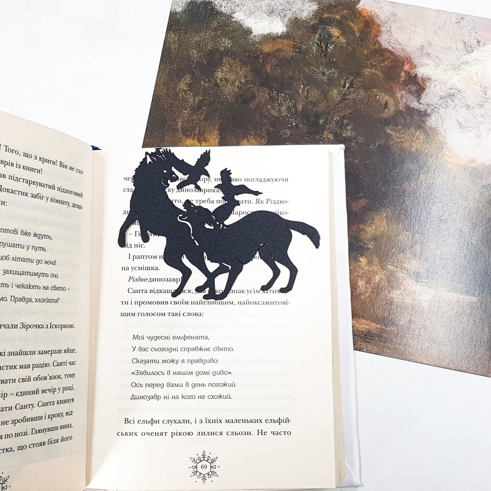 Wolves & Raven metal bookmark shot on a coloured surface