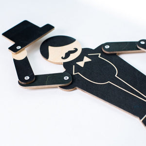 Close-up of gentleman puppet showing mustache detail, bow tie, plywood layers and metal joint rivets