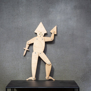 Back view of handmade articulated plywood acrobat puppet showing joints and wall hanging mount