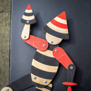 close up of handmade articulated plywood acrobat puppet showing head and upper body details