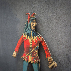 angled view of handmade articulated plywood jester puppet showing thickness and layered construction