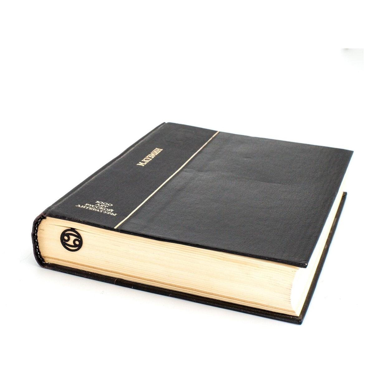 Zodiac Cancer metal bookmark in a closed book, only its top showing above the pages