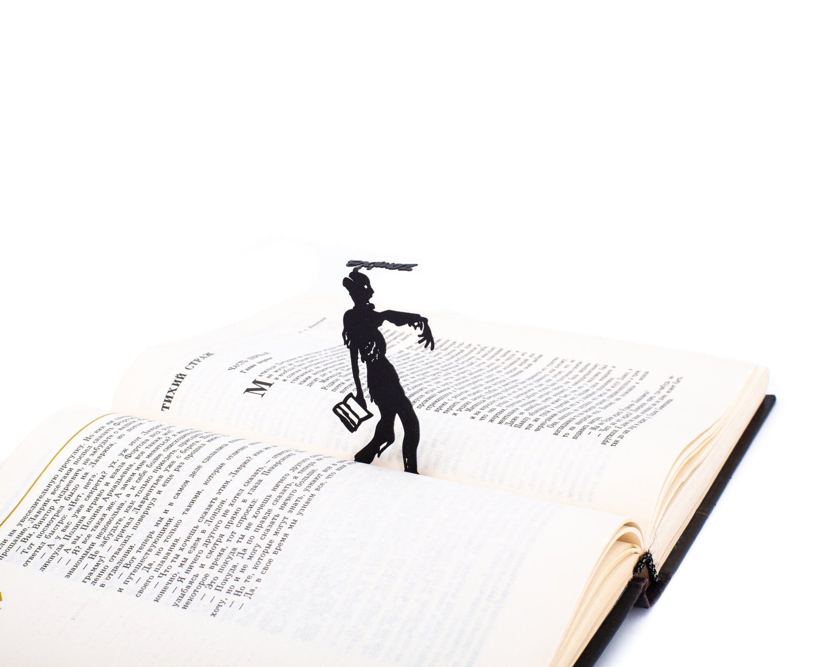 Zombie Walking Dead metal bookmark marking a page in an open book