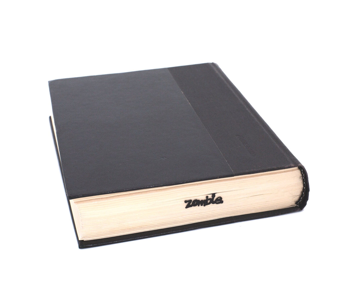 Zombie Walking Dead metal bookmark in a closed book, only its top showing above the pages